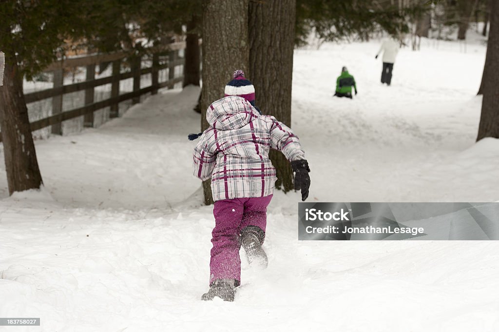 children playing outside in winter runing little girl having fun in snow Child Stock Photo