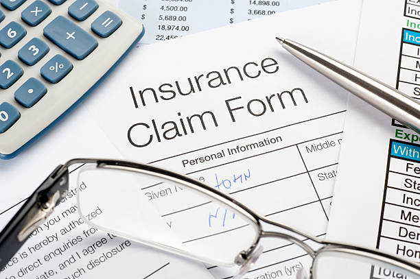 istock Handwritten Insurance Claim Form with pen and calculator 183758079
