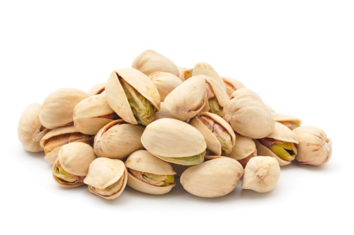 A small pile of Pistachio Nuts isolated on a white background.
