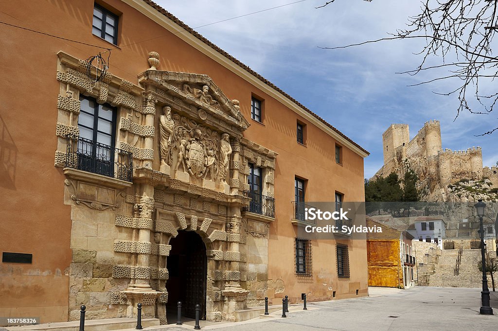 Spanish building. Albacete "Detail of the front door of a building in the town of Almansa (Albacete) Spain, and the background the castle" Arch - Architectural Feature Stock Photo