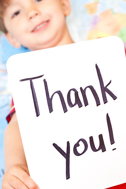 istock Thank You Sign Held By Young Boy at Map 183758507