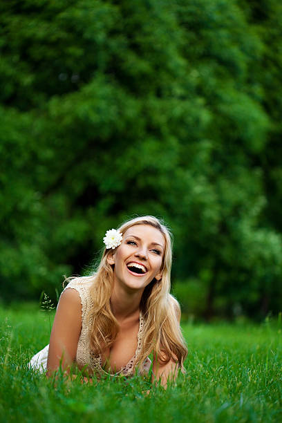 istock Beautiful girl lying down of grass 183758721