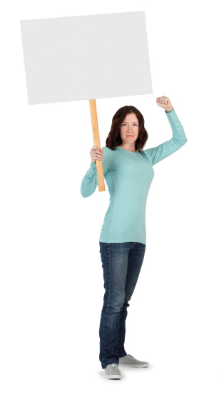 Striking or protesting young woman with fist raised holding a blank sign.