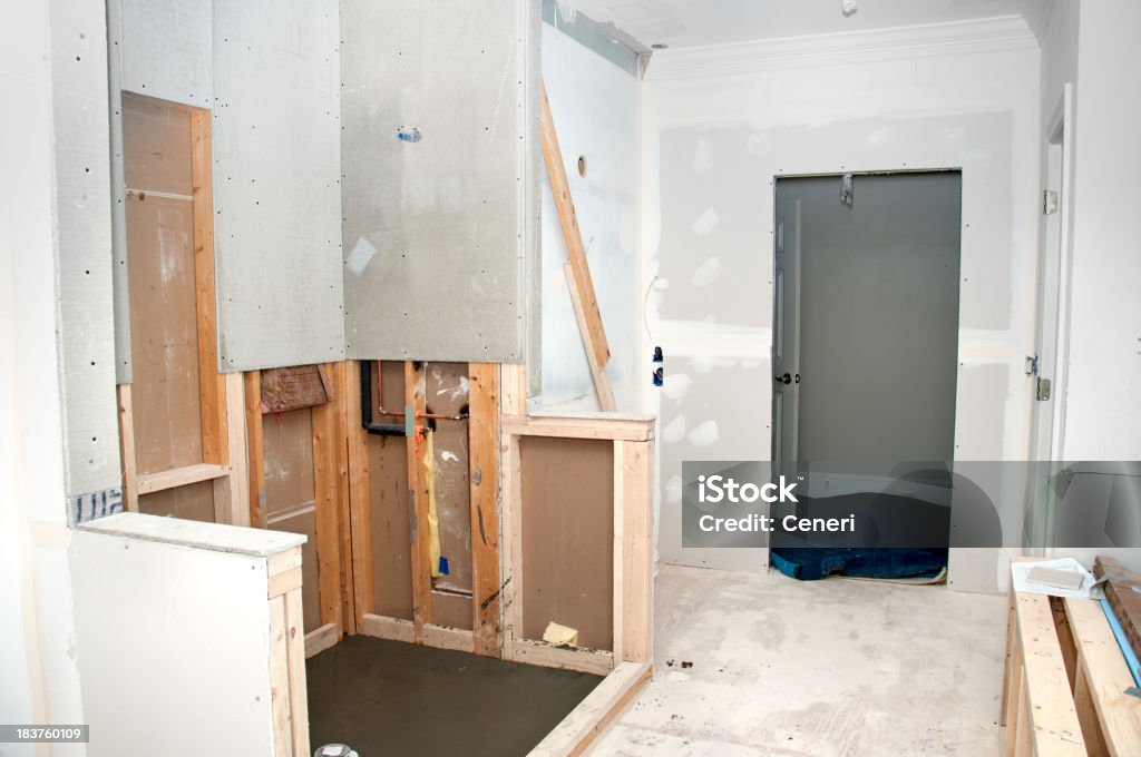 Unfinished renovation of a home bathroom Home Bathroom Renovation: Process of putting up sheet rock onto the stud frames.Related progress images: Bathroom Stock Photo