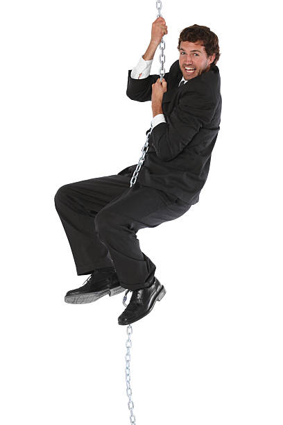 istock Young businessman climbing up chain rope 183760186