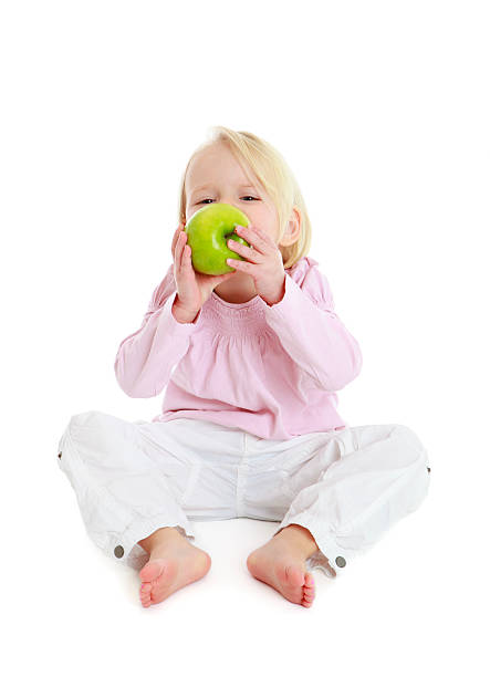 istock Cute girl eating apple 183760216