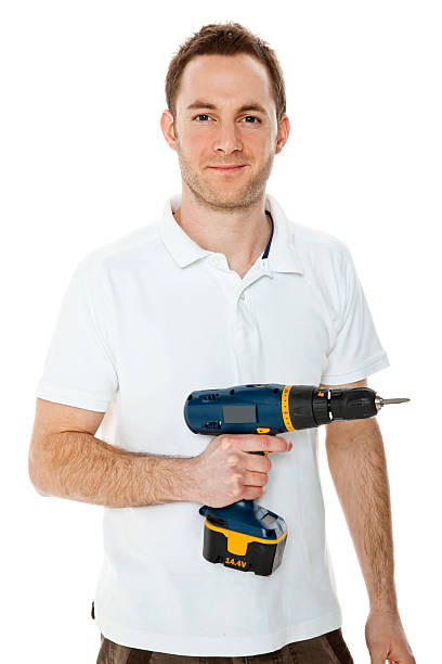 istock Young man holding a drill isolated on white background 183760364