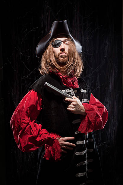 istock Brooding Pirate Buccaneer Man holding flintlock pistol historical garb 183760912