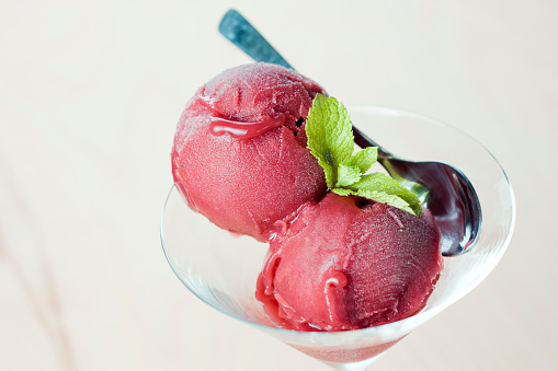delicious strawberry sorbet in martini glass decorated with mint leaves ice cream