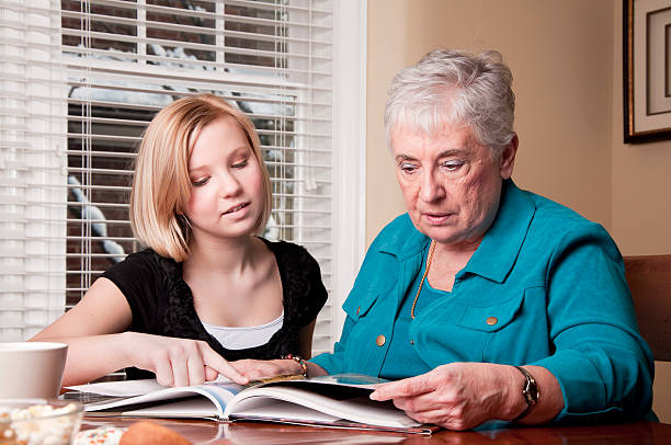 istock Teen and Senior Share a Book 183761301