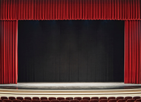 theatre stage with red curtains open