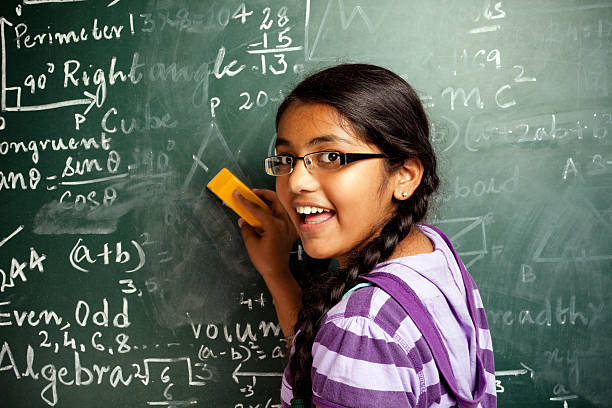 istock Cheerful Indian Girl Student Erasing Mathematics Problems from Greenboard Blackboard 183761830