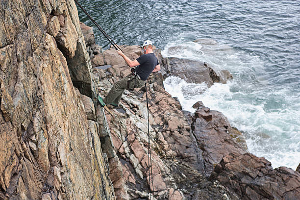 istock Rock climbing on a cliff above the ocean in Maine 183762494
