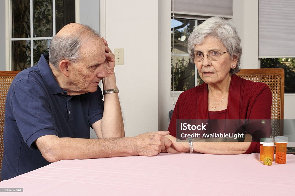 Alzheimer's Woman Holds Husband's Hand "Man comforts wife, who suffers from Alzheimer's disease." Alzheimer's Disease Stock Photo