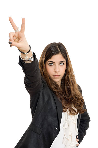 Victory Teenage girl making a peace gesture. Isolated on white. late teens isolated on white one person cute stock pictures, royalty-free photos & images