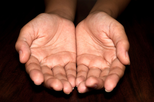Middle Adult Asian Female Cupped Hands On A Dark Background