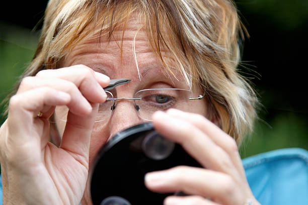 istock Mature woman plucking eyebrows 183763771