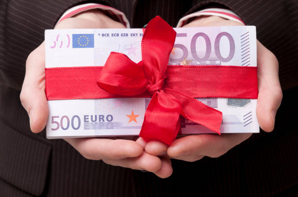 stack of 500 euro banknotes with red ribbon