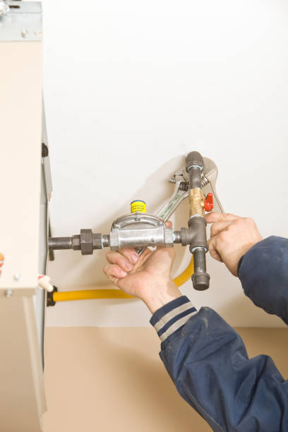 istock Plumber Installing Ceiling Furnace Gas Line 183764176