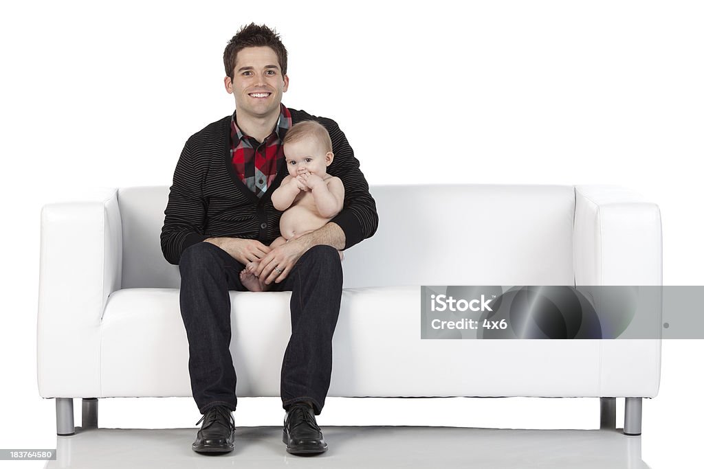 Szczęśliwy człowiek z dziecko siedzi na jego lap - Zbiór zdjęć royalty-free (20-29 lat)