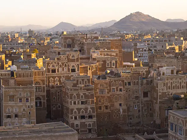 "Beautiful skyscrapers and minarets in old city in Sanaa in the evening, high angle view. Yemen."