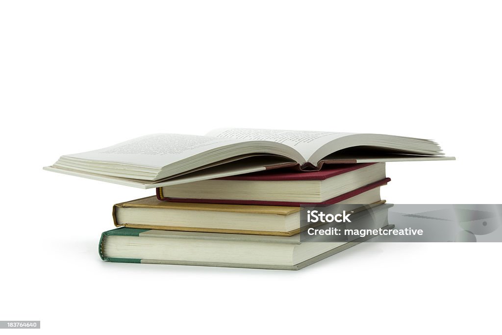 Books Stacked Up A stack of books with the top one open Book Stock Photo