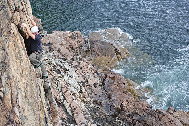istock Rock climbing on a cliff above the ocean in Maine 183764837