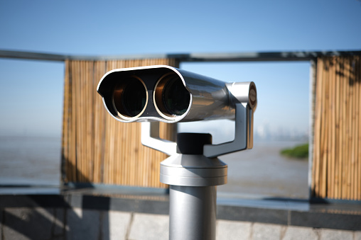 Tourist coin operated telescope looking out over a city view