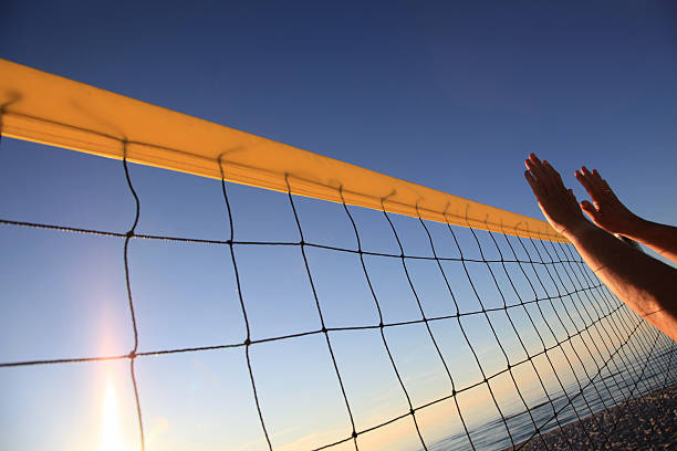 istock Backlight shot of hands playing beach volleyball 183764876