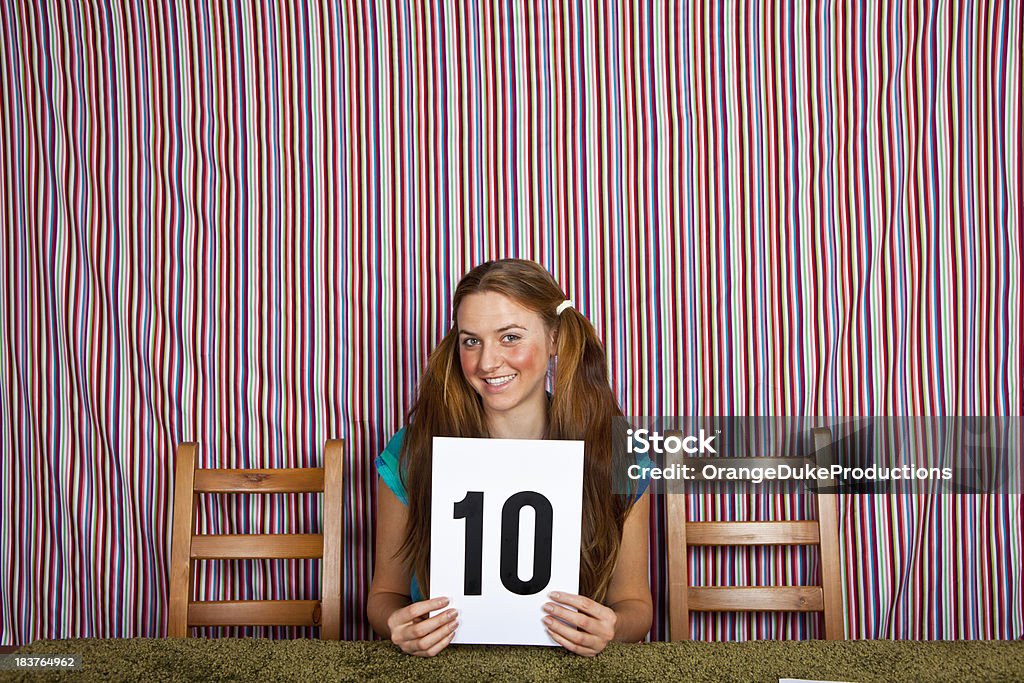 Girl judge holding up the perfect score "Girl judge holding up the perfect scoreFOR MORE IMAGES IN THIS SERIES, PLEASE VISIT OUR LIGHTBOX:" Number 10 Stock Photo