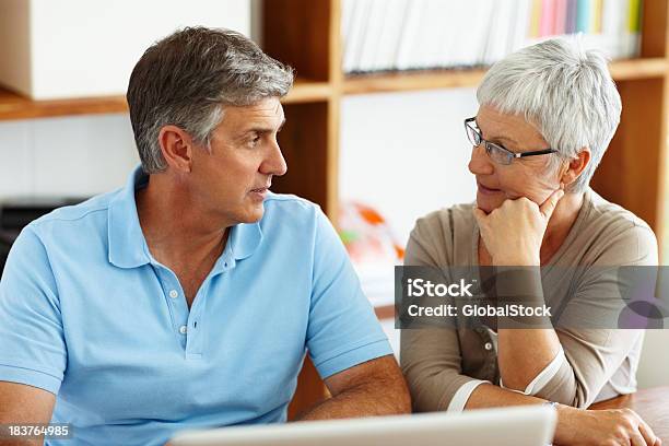 Mature Couple Discussing Their Future Plans Stock Photo - Download Image Now - Computer, Couple - Relationship, In Front Of