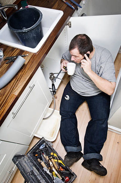 istock Plumber At Work On The Phone 183765064