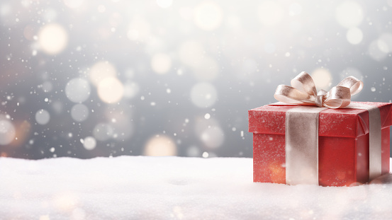 Red Gift Box in Snow with Bokeh Background