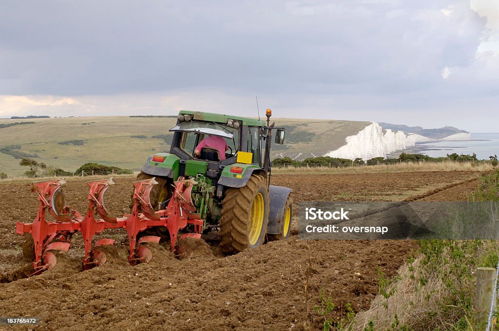 Plough "A farmer ploughs with a tractor on the South Downs of East SussexEngland, UK" UK Stock Photo