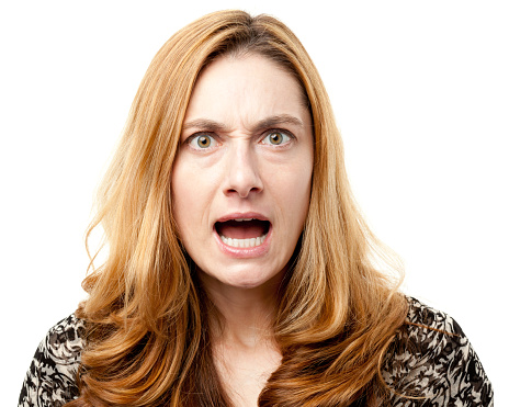 Fearful adult woman with blond hair on white background with copy space.