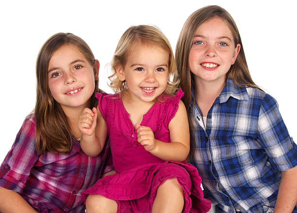 istock Three  Beautiful Young Sisters Smiling on White Background 183765900