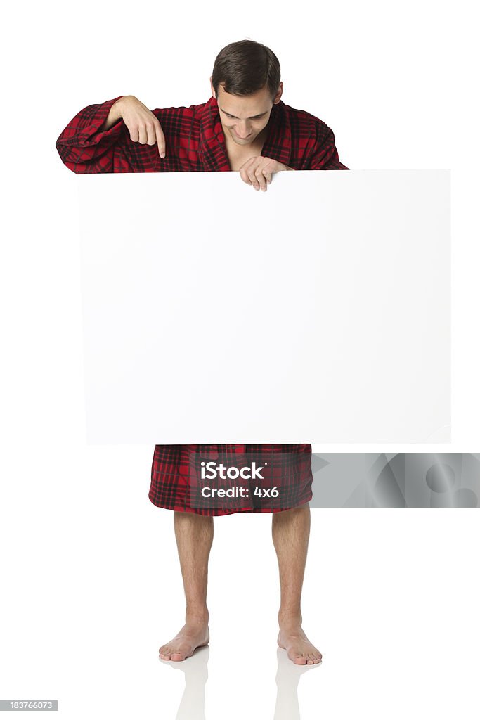 Man standing in robe holding poster and pointing at it Man standing in robe holding poster and pointing at ithttp://www.twodozendesign.info/i/1.png Holding Stock Photo