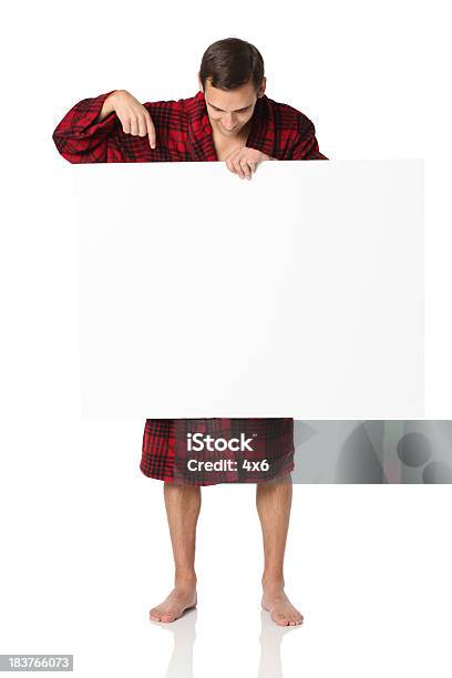 Man Standing In Robe Holding Poster And Pointing At It Stock Photo - Download Image Now