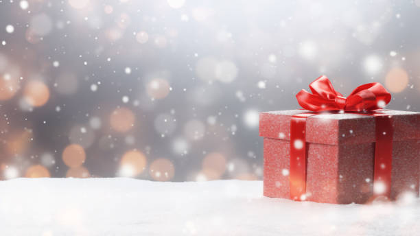 istock Red Gift Box in Snow with Bokeh Background 1837672578