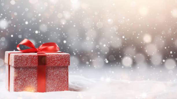 istock Red Gift Box in Snow with Bokeh Background 1837674332