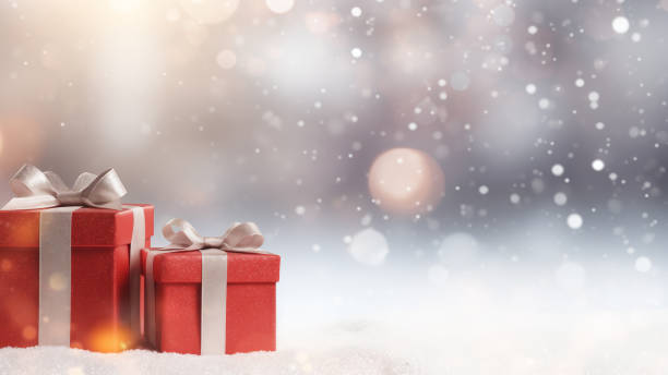 istock Red Gift Box in Snow with Bokeh Background 1837676314