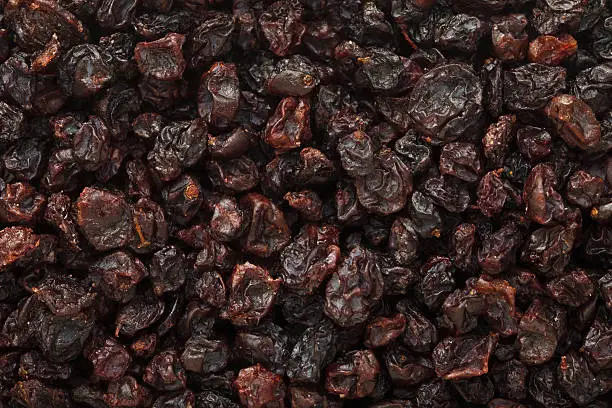 Raisin background from black Corinth dried grapeFood background pictures from