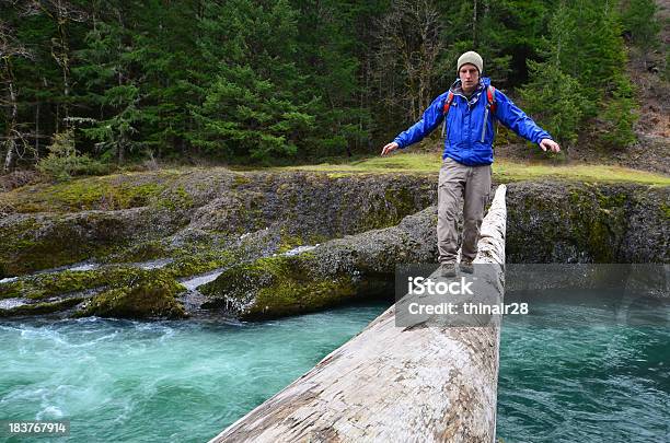 Hiker Crossing Log Stock Photo - Download Image Now - 20-29 Years, Adult, Adults Only