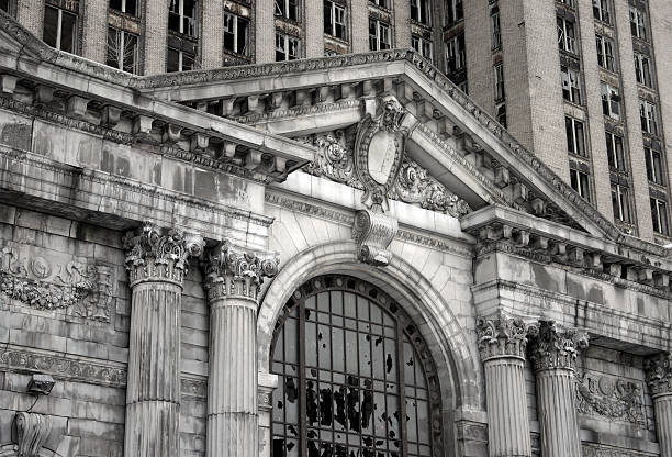 Abandoned Detroit Michigan Central Train Station "A close-up view of the abandoned Michigan Central Station in Detroit, Michigan.Some grain and texture for a dark, gritty feel." detroit michigan photos stock pictures, royalty-free photos & images