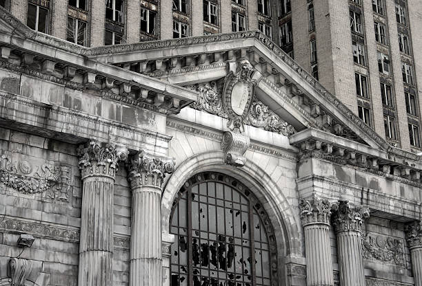 Abandoned Detroit Michigan Central Train Station "A close-up view of the abandoned Michigan Central Station in Detroit, Michigan.Some grain and texture for a dark, gritty feel." train station black and white stock pictures, royalty-free photos & images