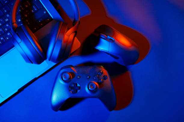 istock Headphones, joystick and computer keyboard on black table 1837682797