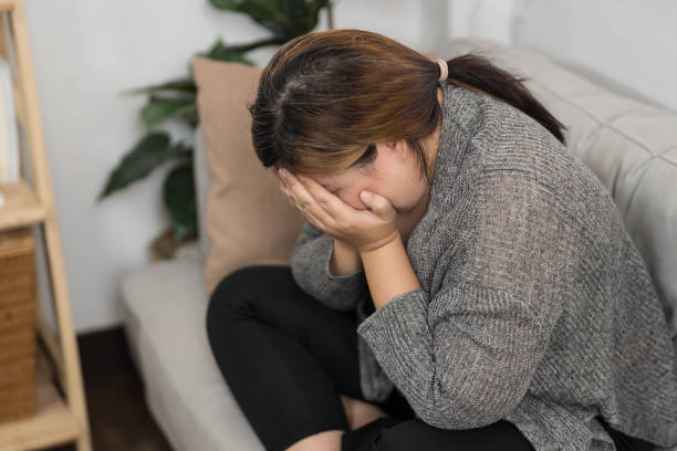 istock Sad Overweight plus size woman thinking about problems on sofa upset girl feeling lonely and sad from bad relationship or Depressed woman disorder mental health. 1837683339