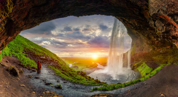 istock Natural cave with sunset over Seljalandsfoss waterfall flowing in summer at Iceland 1837684562