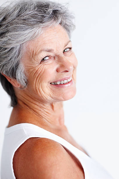 istock Senior woman smiling while looking at you 183769136