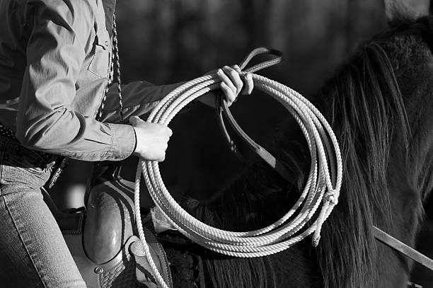 rodeo roper cow-girl b & w - travel buckle part of on top of photos et images de collection